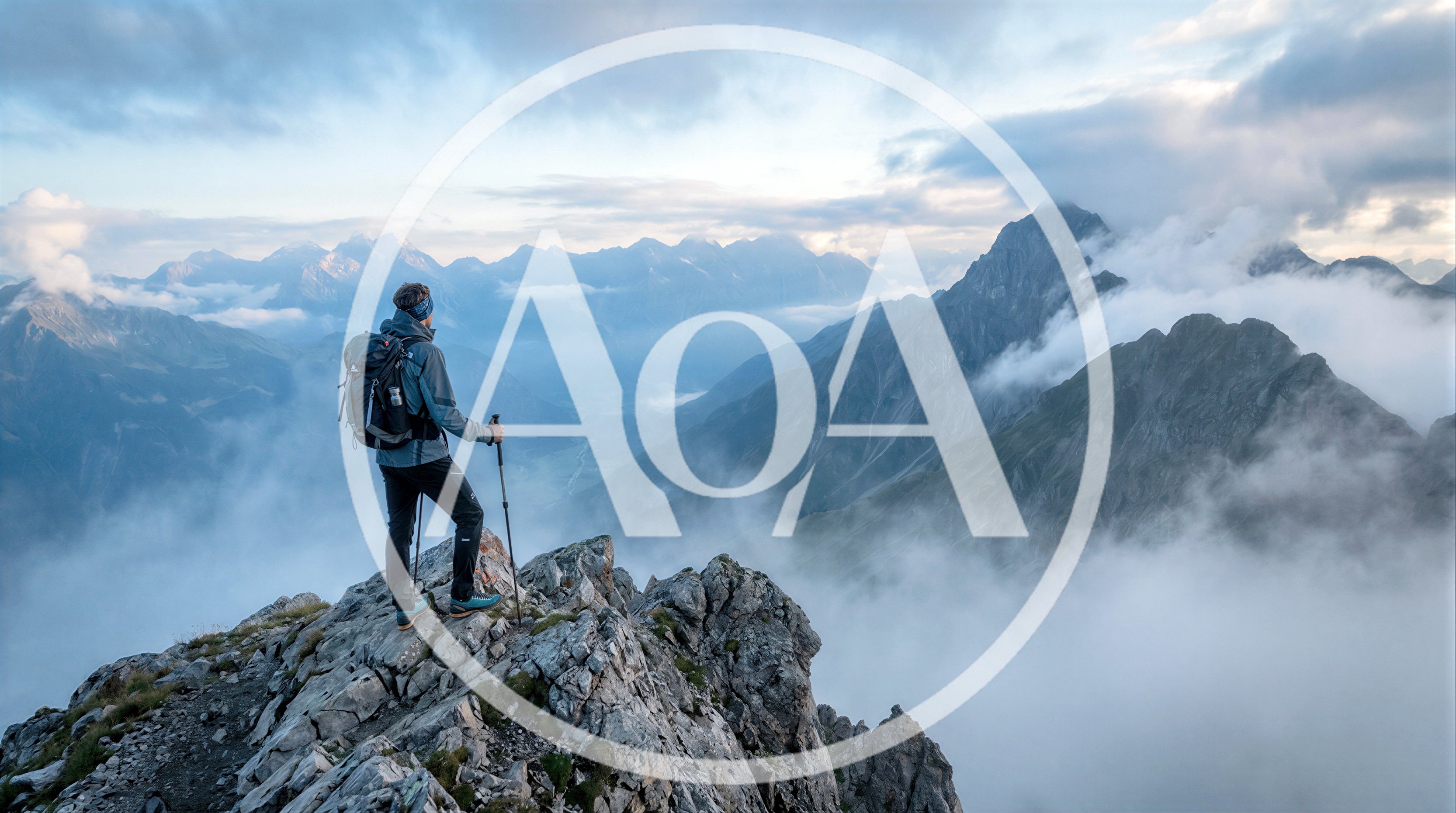 Hiker Standing On Mountain Peak Above Clouds