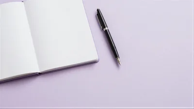 Open Notebook With Fountain Pen On Purple Background