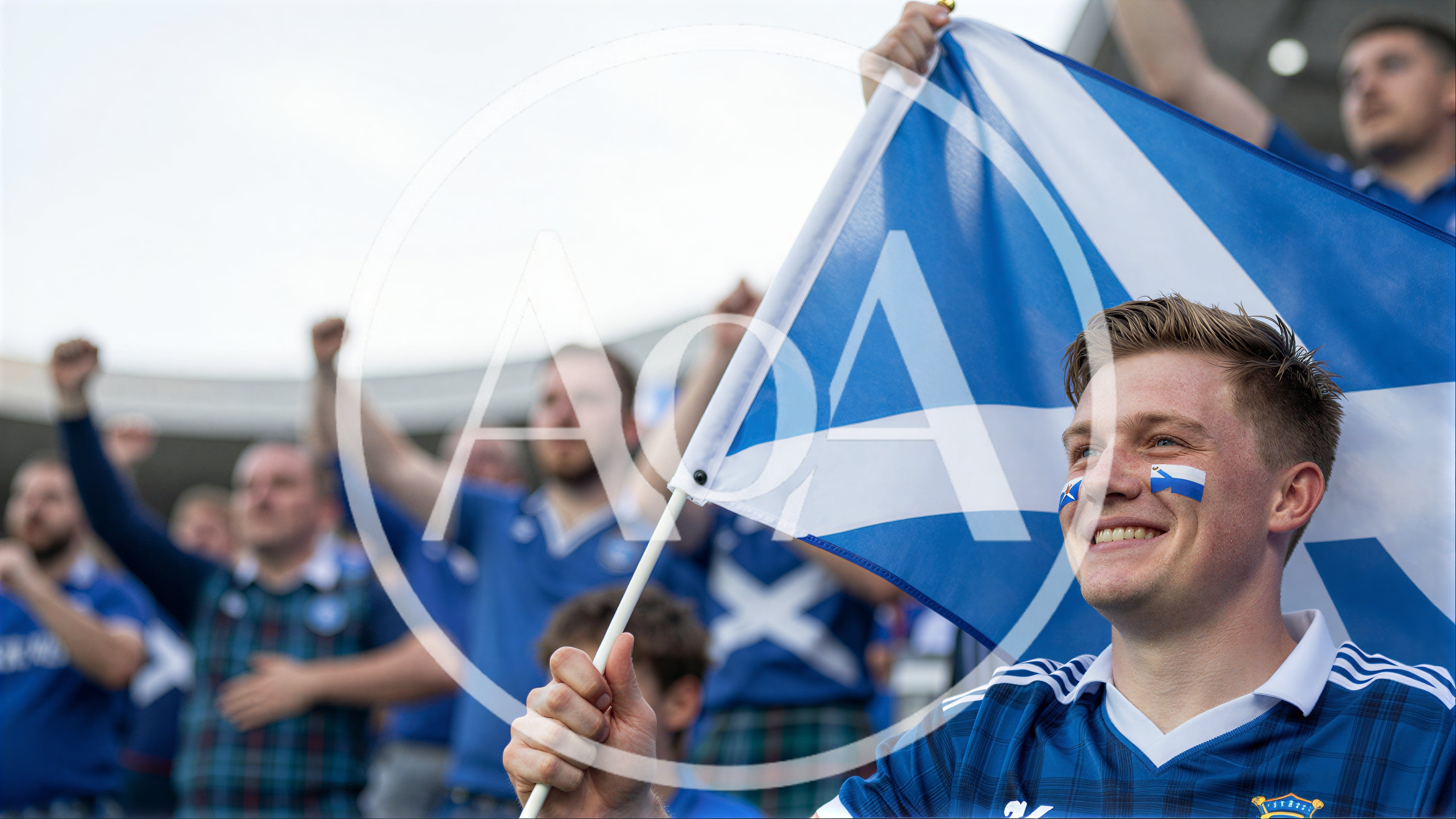 Scottish Football Fans Cheering With Flag In Stadium