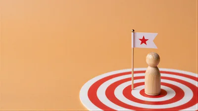 Wooden Figurine Standing On Target With Star Flag