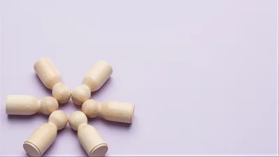 Wooden Peg Dolls Arranged In A Circular Pattern