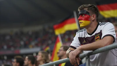 German Soccer Fan With Face Paint Watching Match