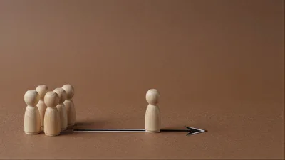 Wooden Peg Dolls Representing Leadership And Teamwork