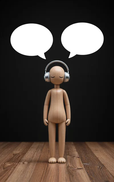 Wooden Mannequin Wearing Headphones With Blank Speech Bubbles