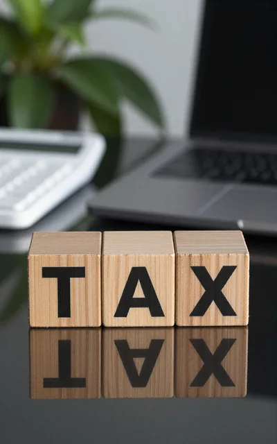 Wooden Blocks Spelling Tax on Office Desk