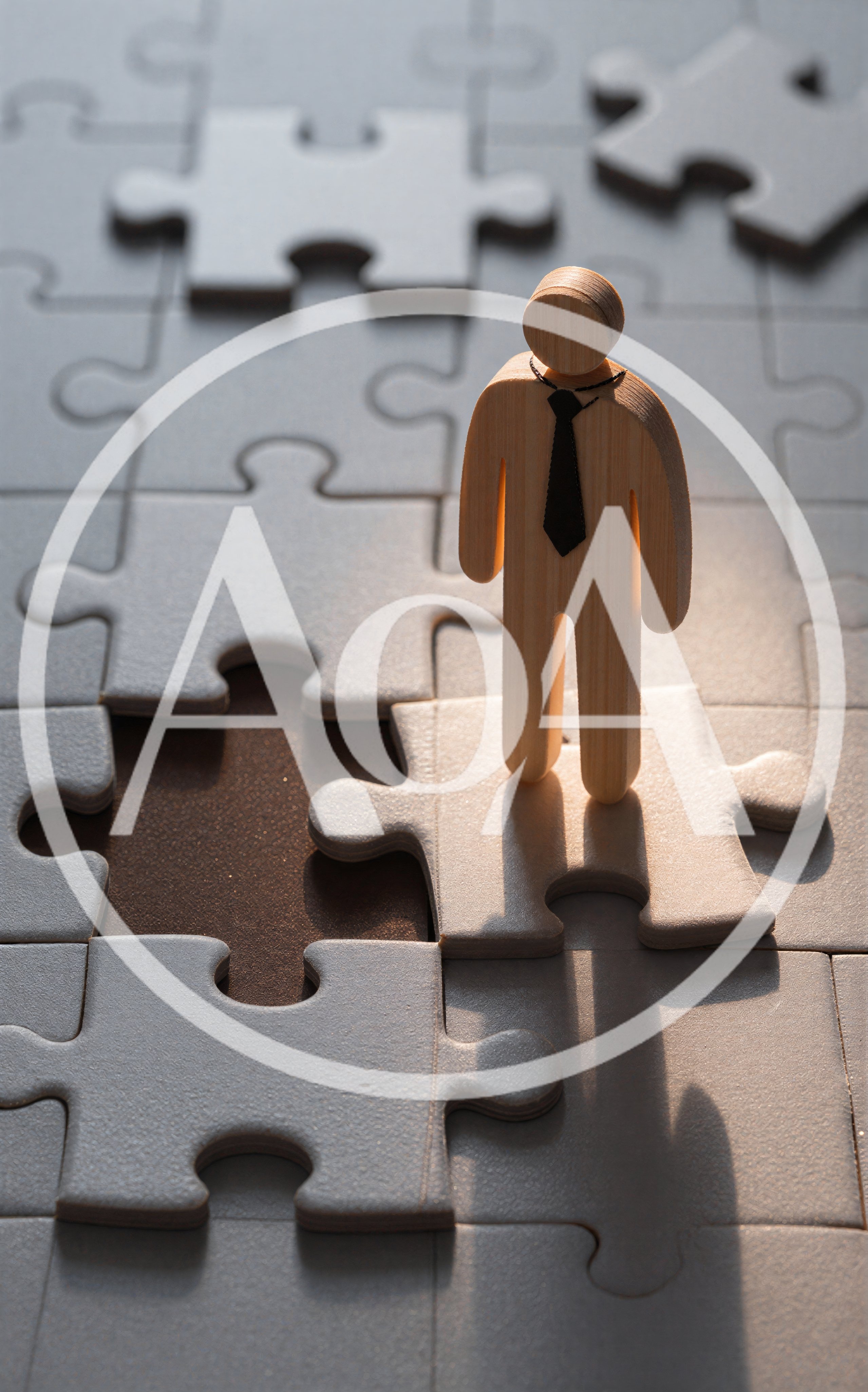 Wooden Figurine Standing On A Jigsaw Puzzle Piece