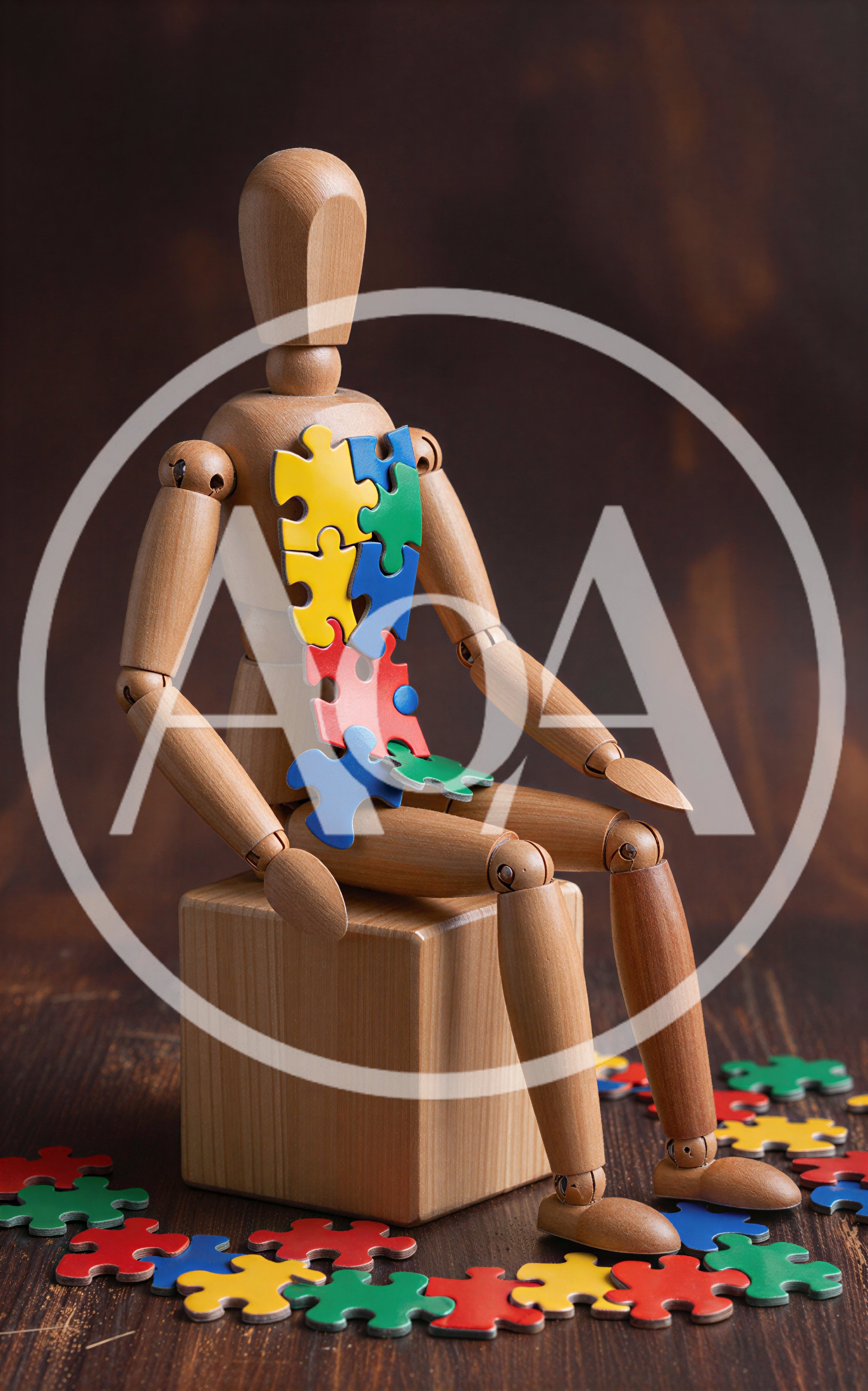 Wooden Mannequin Sitting With Colorful Puzzle Pieces