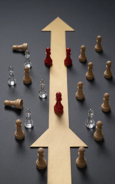 Red Chess Pieces Leading On Gold Arrow Path
