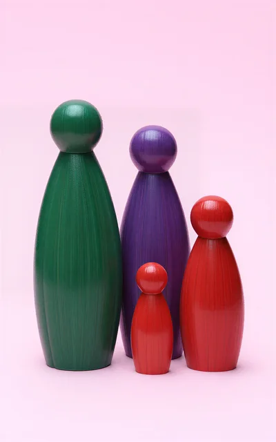 Four Colorful Wooden Peg Dolls On Pink Background