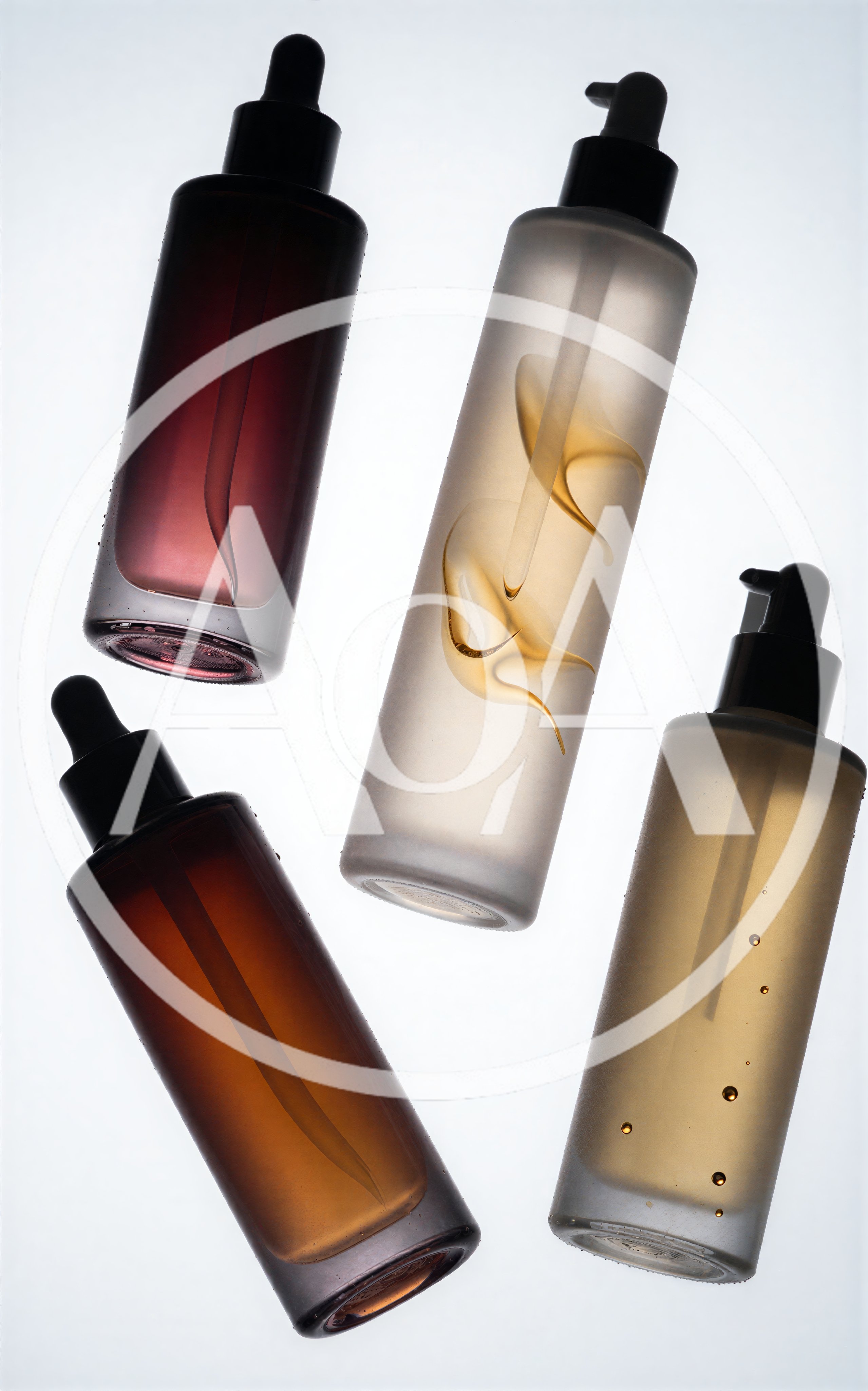 Four Cosmetic Bottles With Dropper Caps On White Background