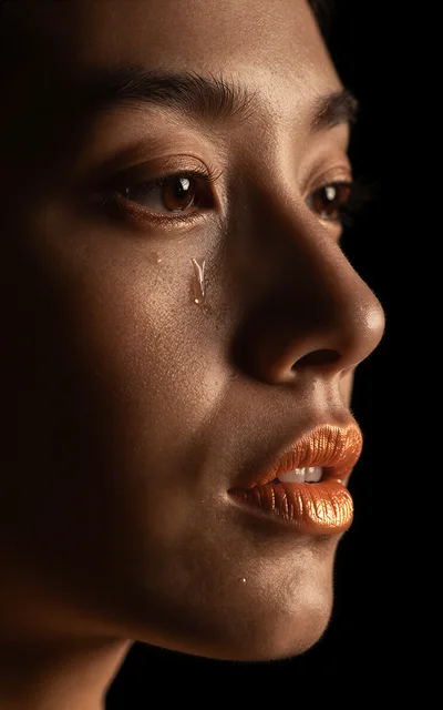 Close Up Portrait Of A Woman With A Tear