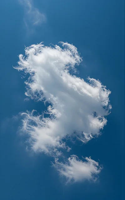 Wispy White Cloud Floating In Clear Blue Sky