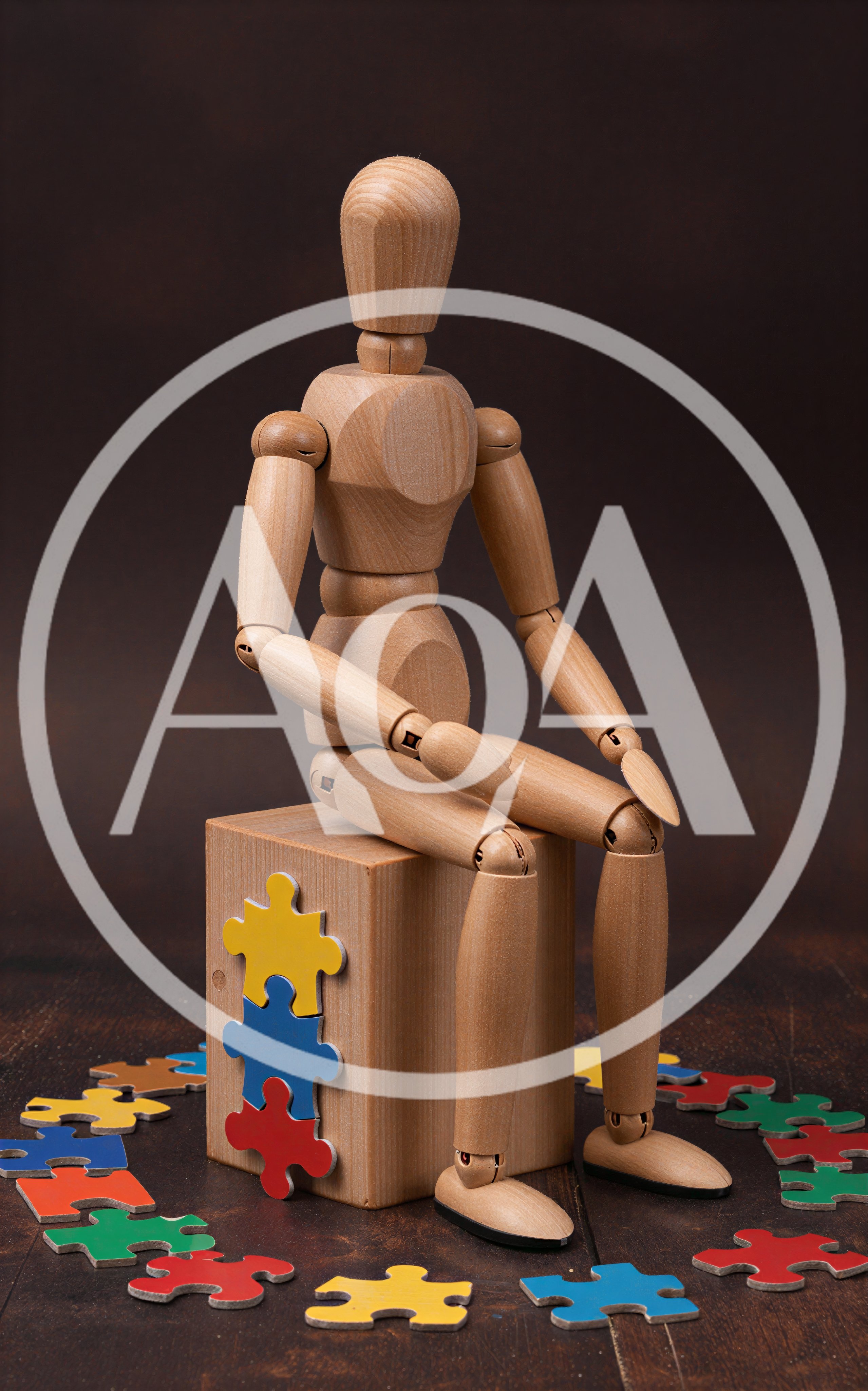 Wooden Mannequin Sitting on Block with Puzzle Pieces