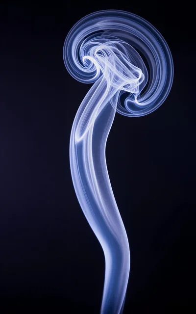 Abstract Blue Smoke Swirls Against Black Background