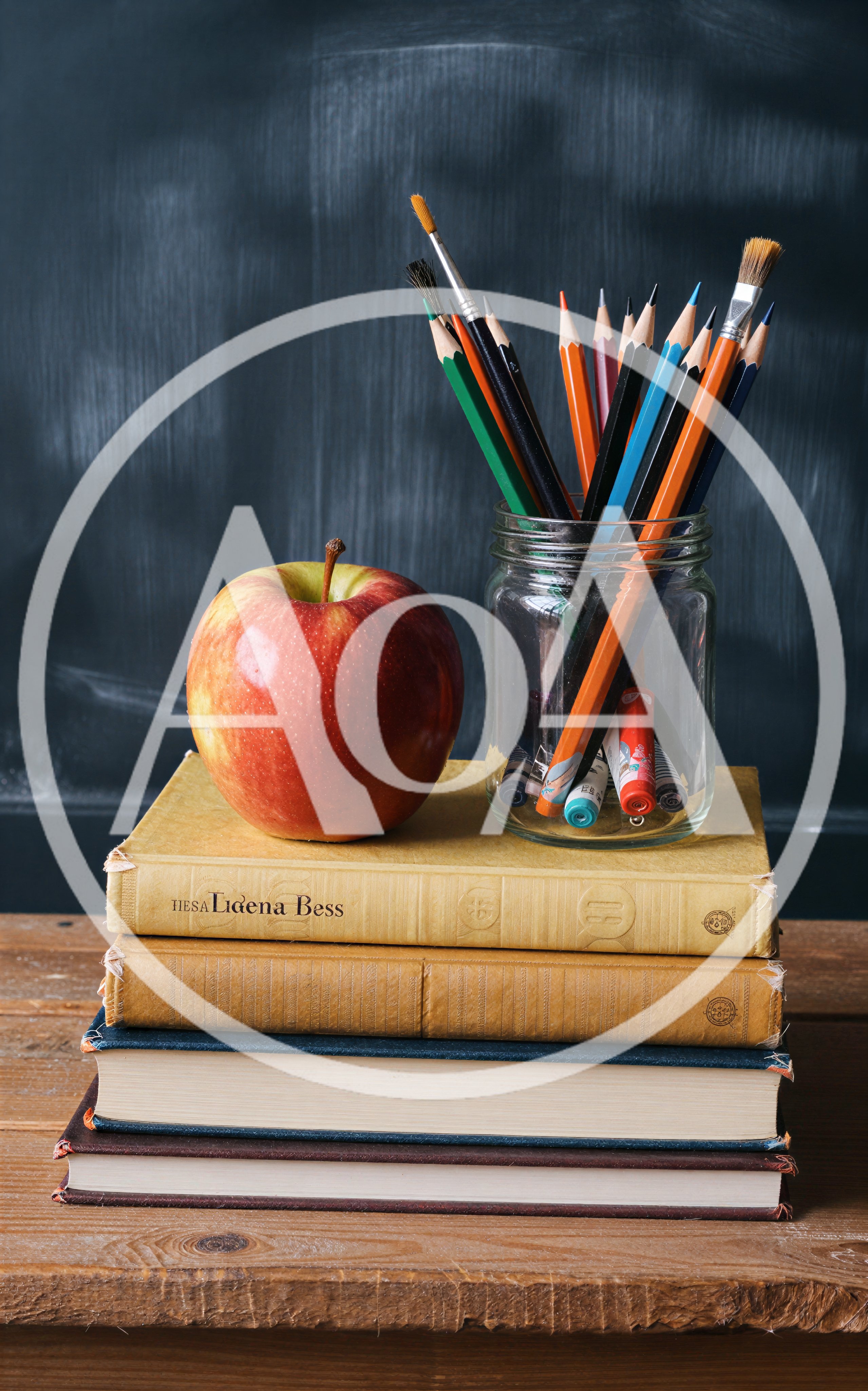 Apple and Pencils on Stack of Books
