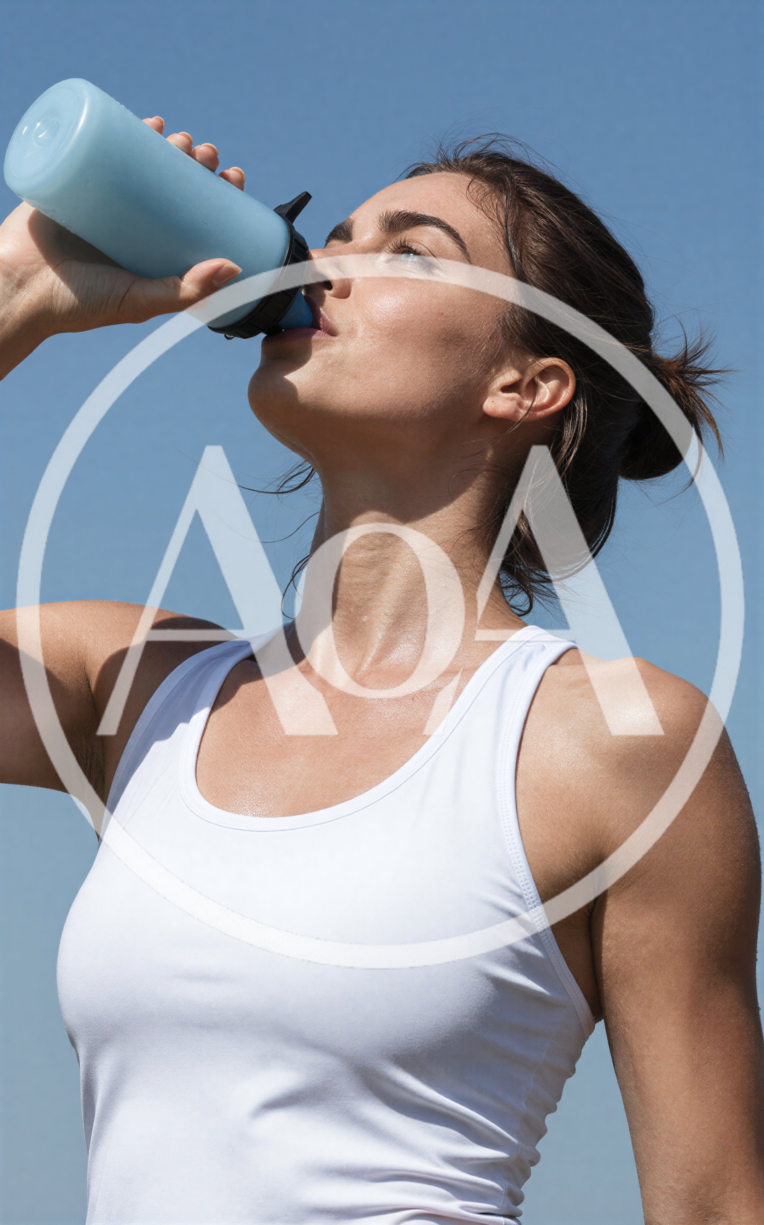 Athletic Woman Drinking Water From A Blue Bottle