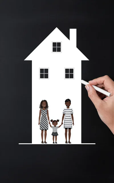 Hand Drawing A Family Home On A Blackboard