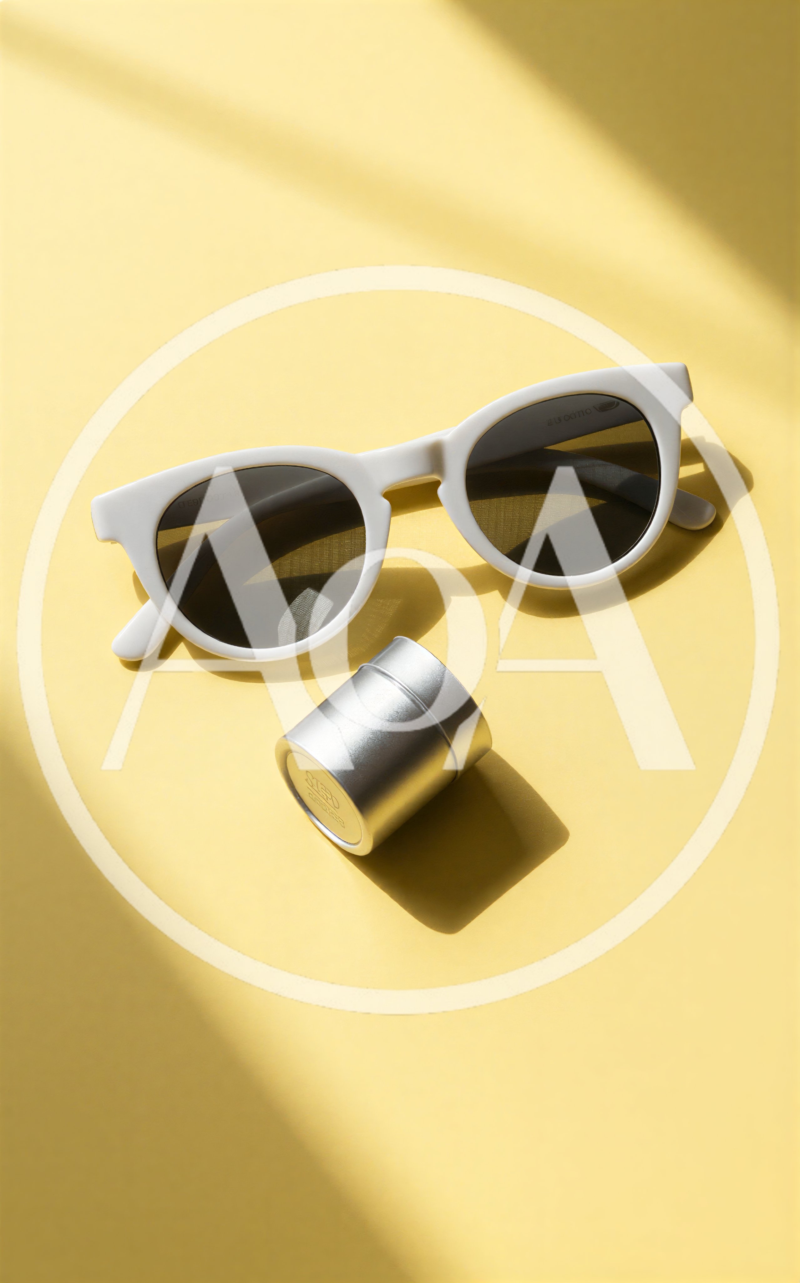 White Sunglasses And Silver Tin On Yellow Background
