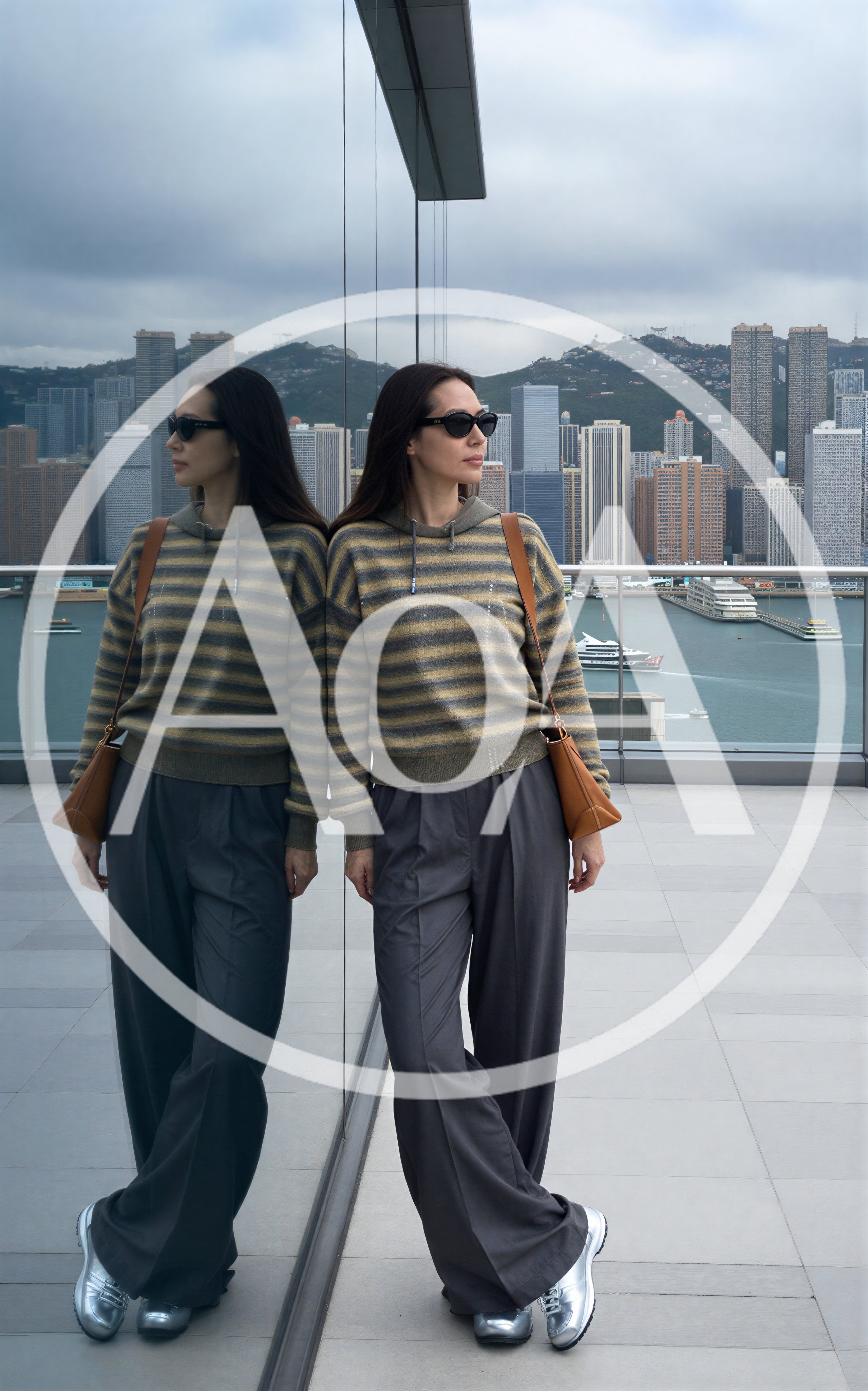 Woman Leaning Against Glass Wall Overlooking Hong Kong Skyline