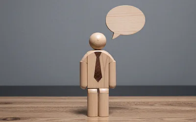 Wooden Mannequin Figure With Blank Speech Bubble
