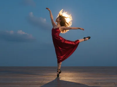 Ballerina Dancing In Red Dress At Sunset
