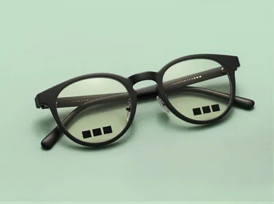 Black Rimmed Eyeglasses On A Light Green Background