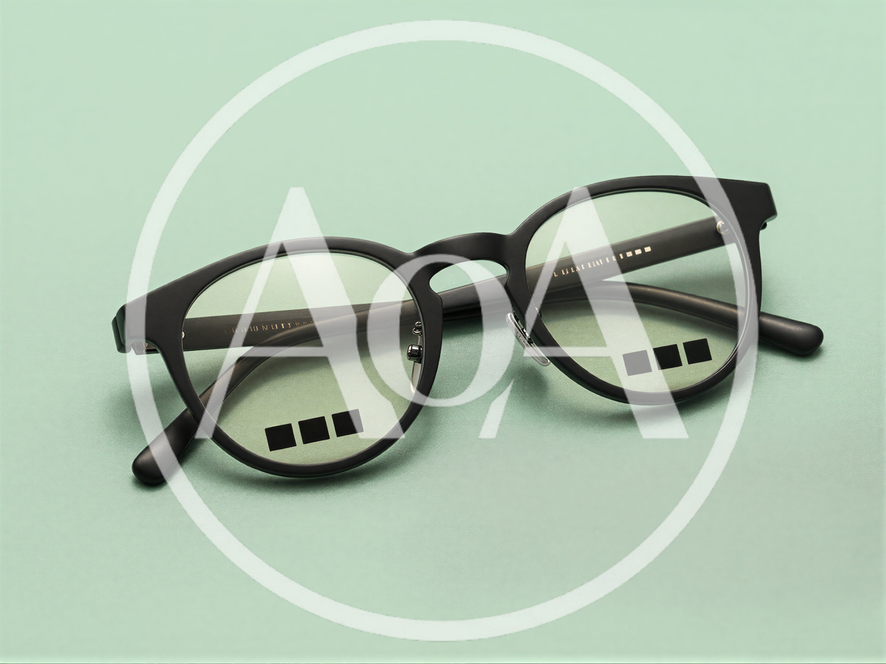 Black Rimmed Eyeglasses On A Light Green Background
