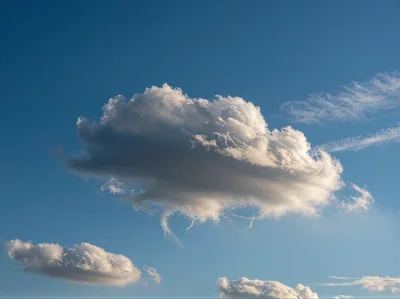 Single Large Cumulus Cloud Against Clear Blue Sky