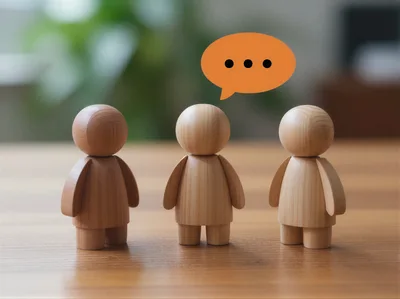 Three Wooden Figurines Representing Communication and Teamwork