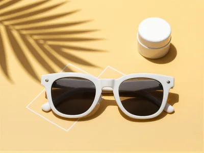 White Sunglasses and Skincare Jar on Yellow Background