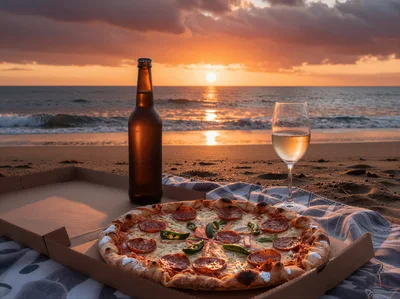 Pizza and Drinks on a Beach at Sunset