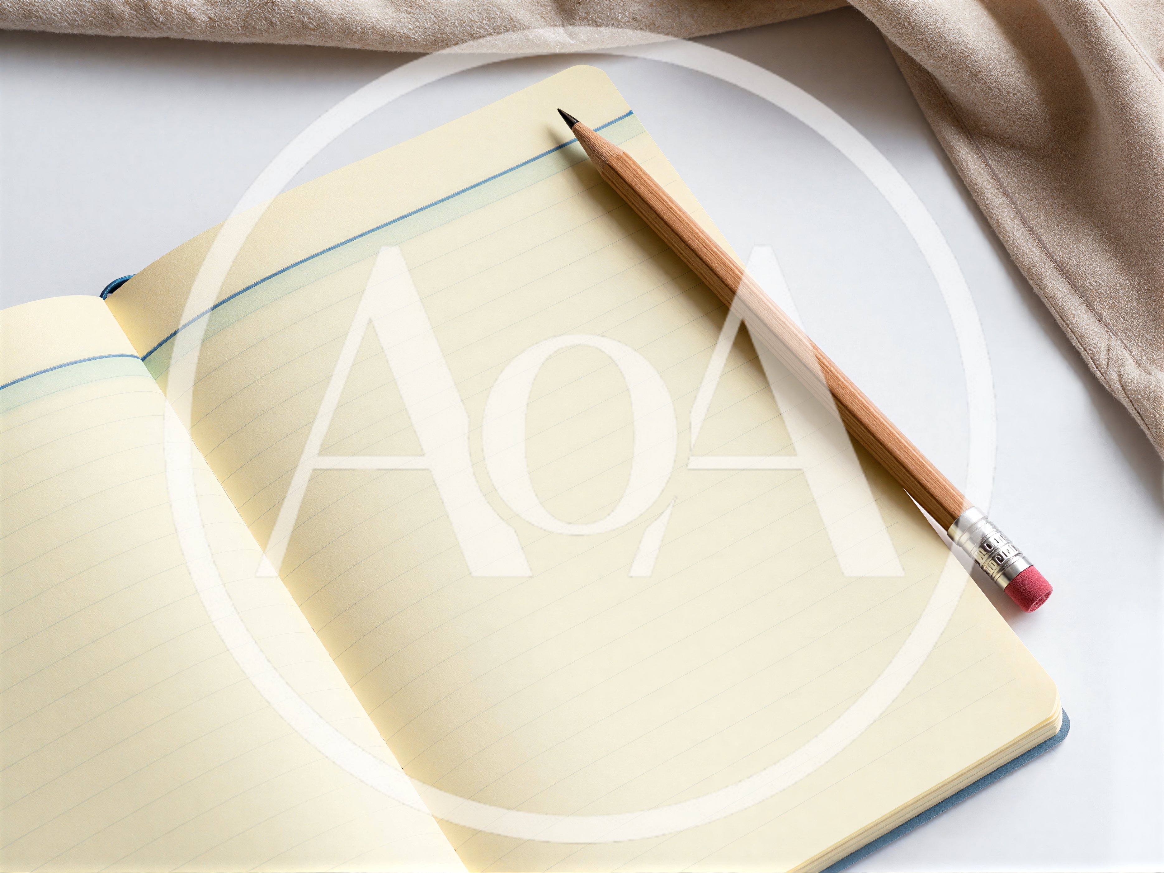 Open Notebook With Pencil On A White Surface