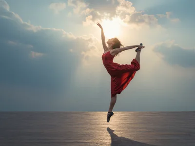 Ballerina Performing A Graceful Leap Against Sunset Sky