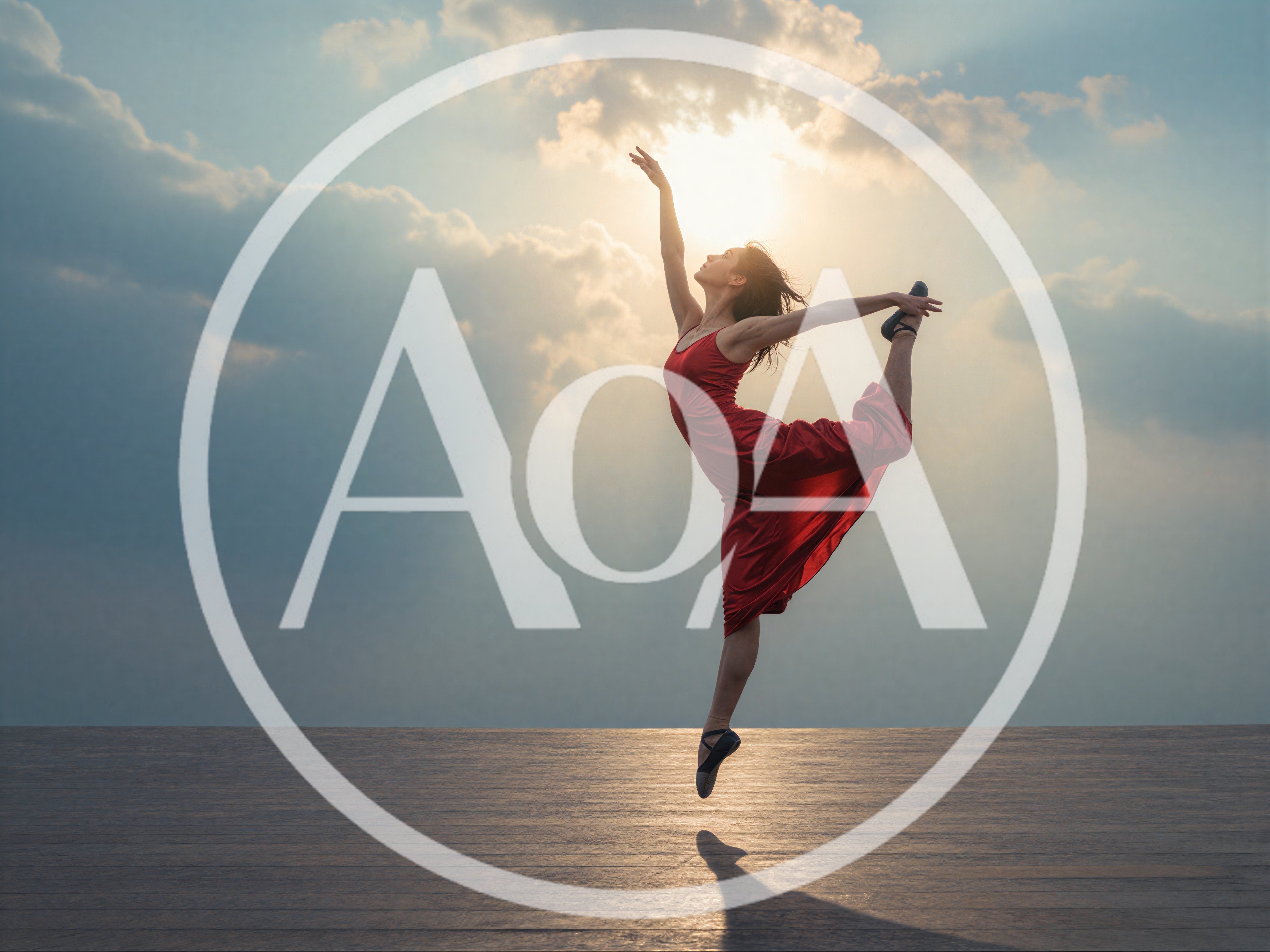 Ballerina Performing A Graceful Leap Against Sunset Sky