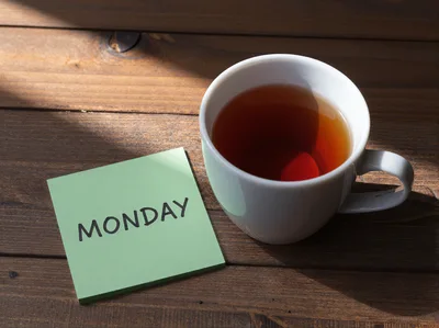 Green Sticky Note With Monday Text And Tea Cup