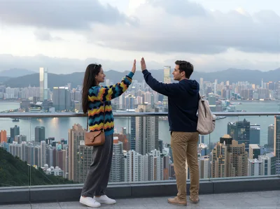 Couple Giving High Five Overlooking Hong Kong Skyline