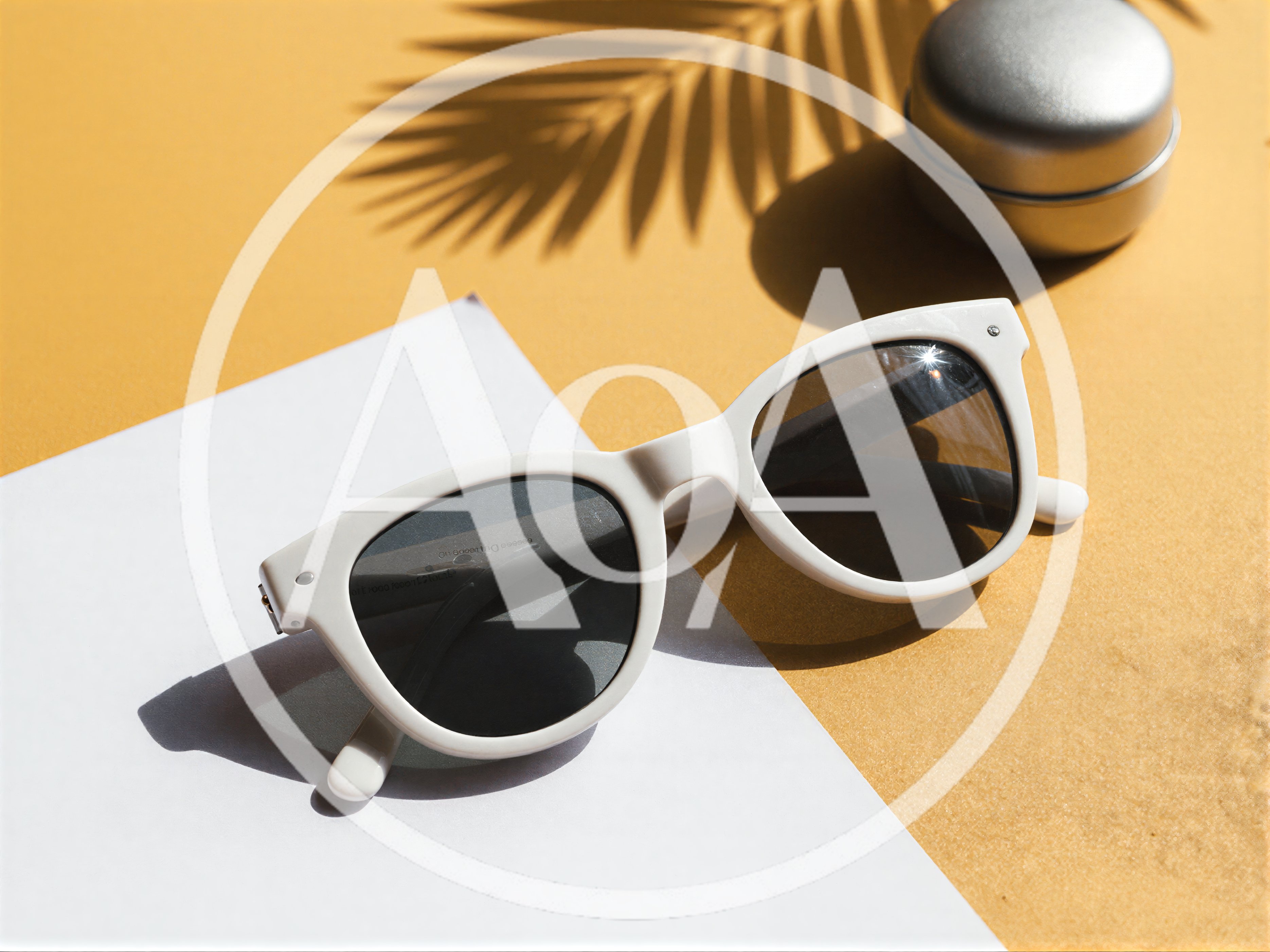 White Sunglasses And Silver Container On Yellow Background