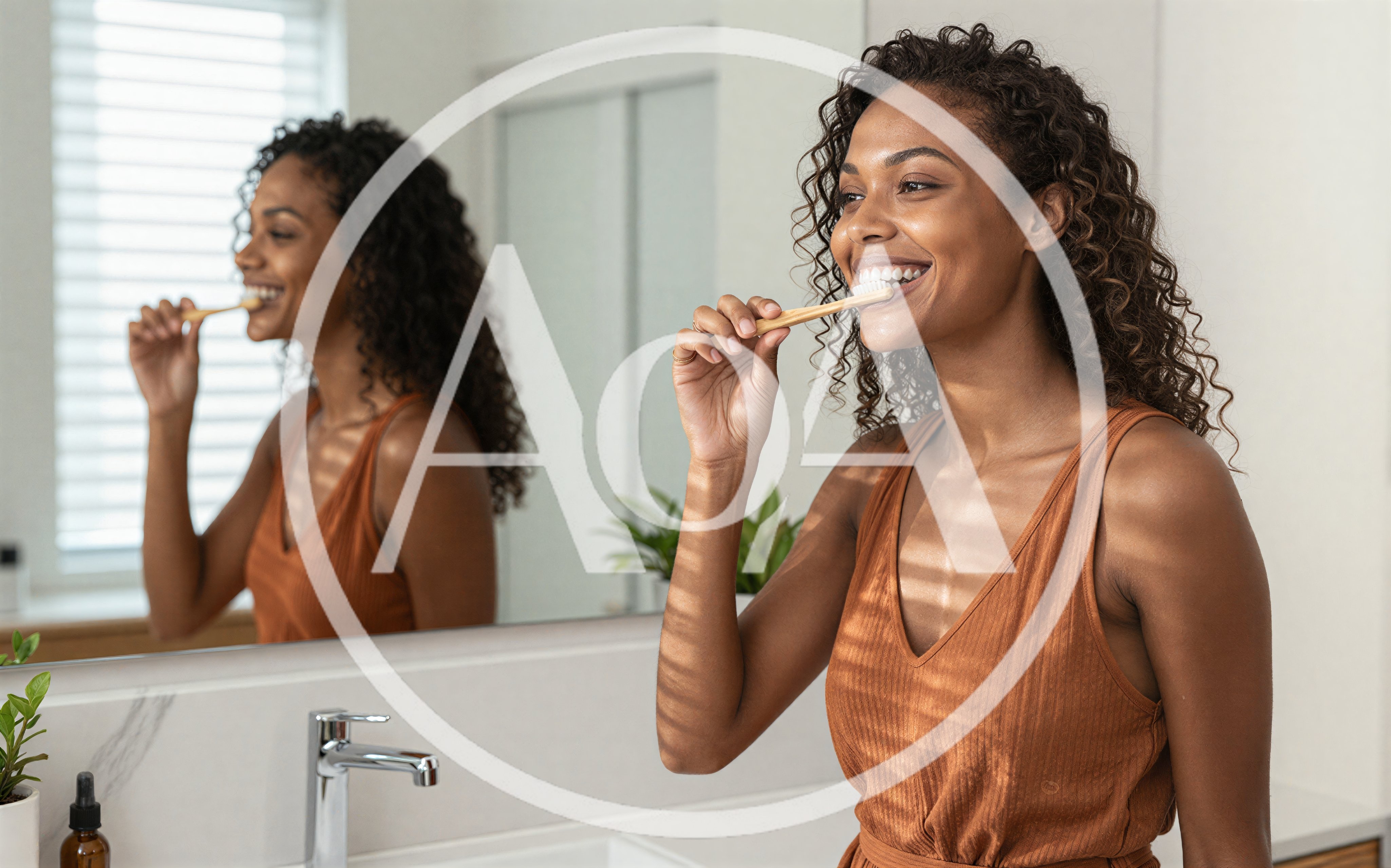 Young Woman Brushing Teeth In Bathroom Mirror