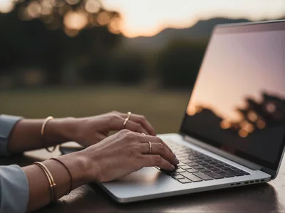 Woman Typing On Laptop Outdoors At Sunset