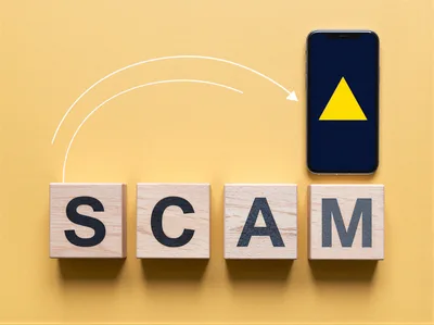 Wooden Blocks Spelling Scam With Smartphone And Arrow