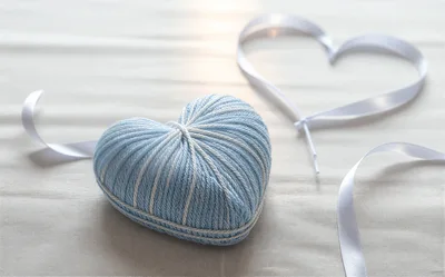 Blue Yarn Heart and White Ribbon on Fabric