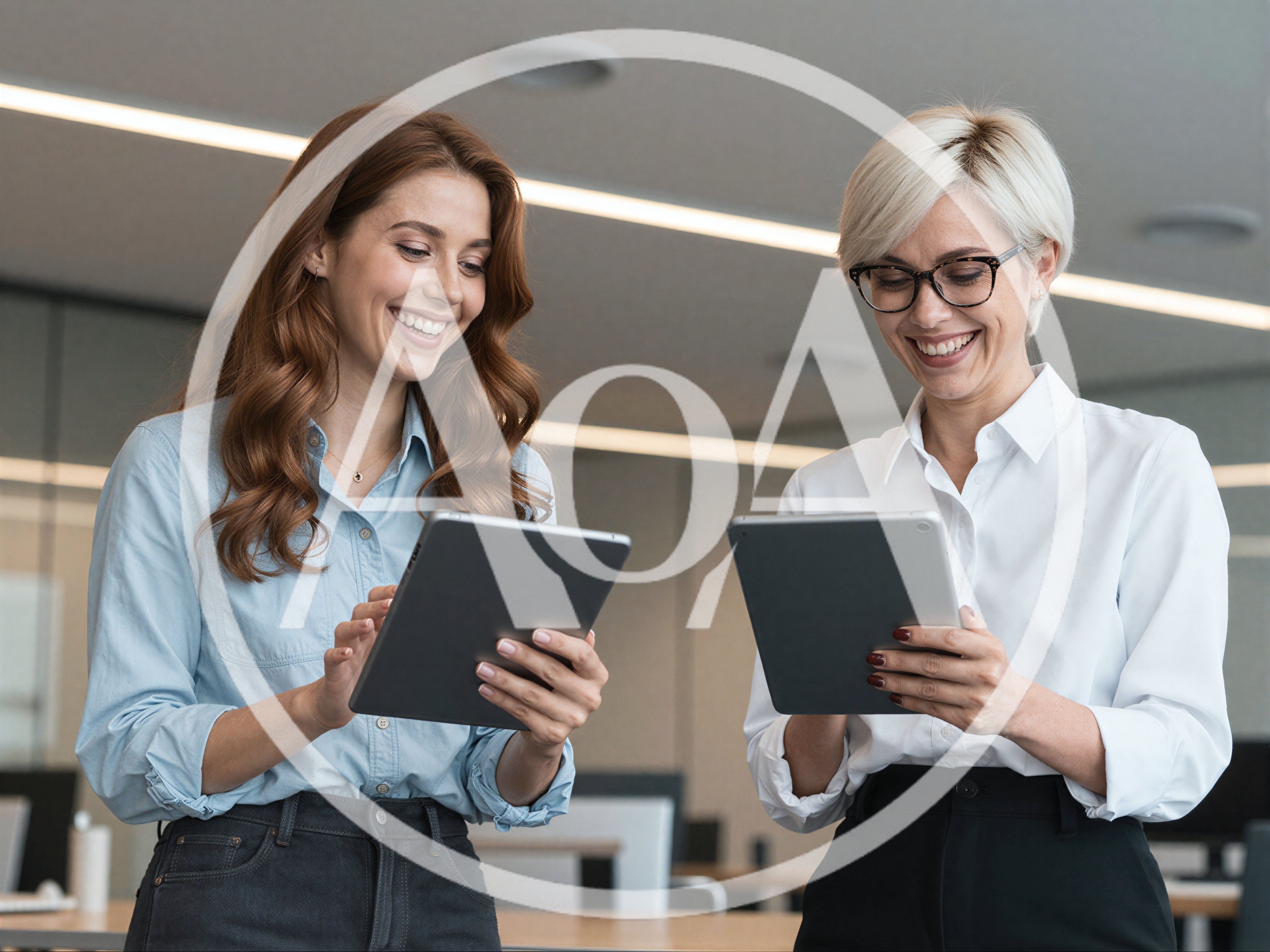 Two Professional Women Collaborating With Tablets In Office