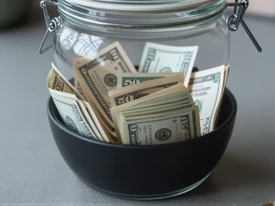US Dollar Banknotes Stored Inside A Glass Jar