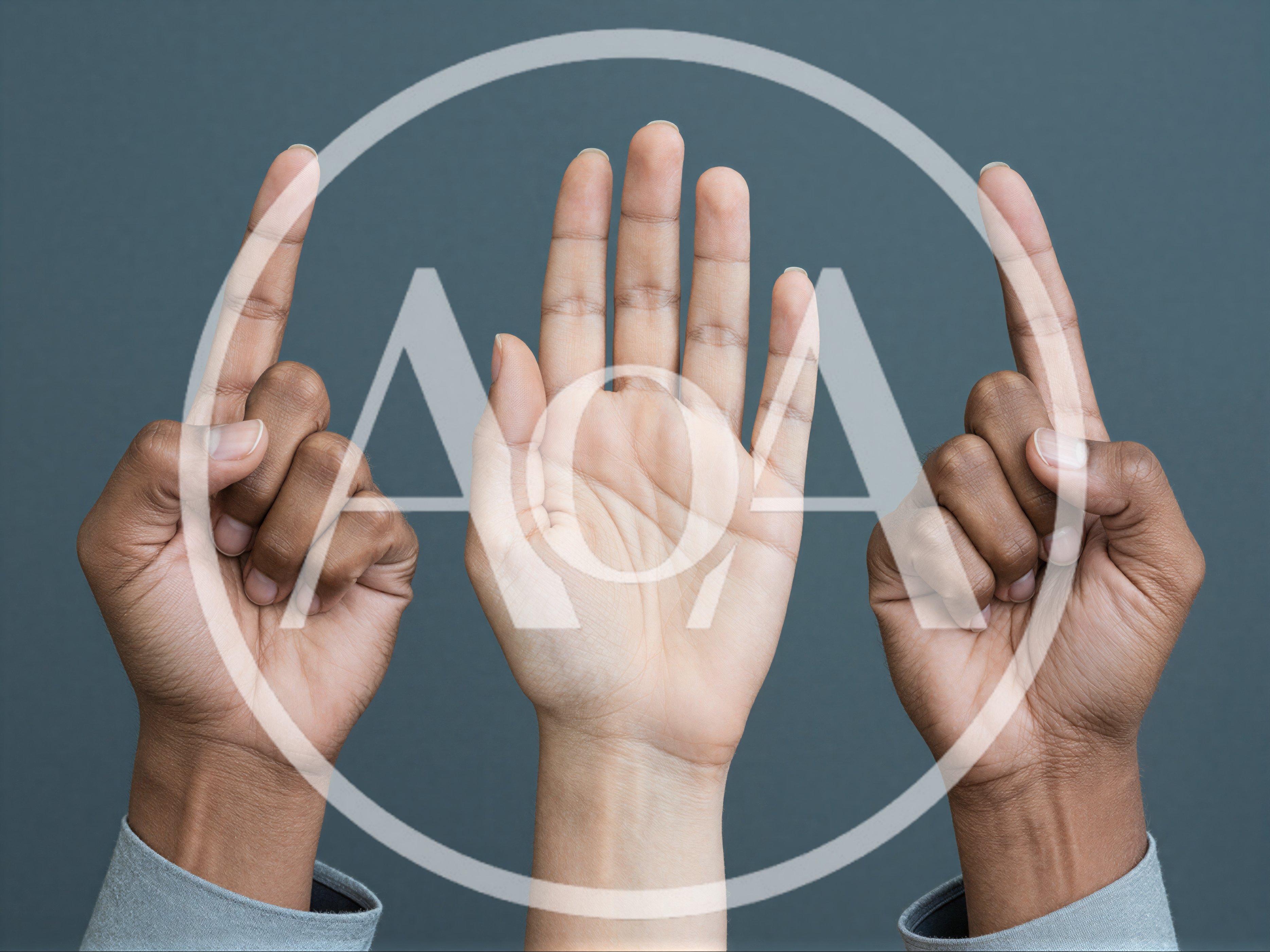Three Hands Raised Against A Grey Background