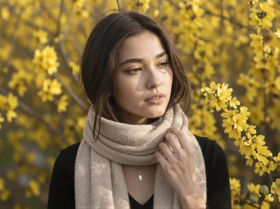 Young Woman Wearing Beige Scarf Among Yellow Flowers