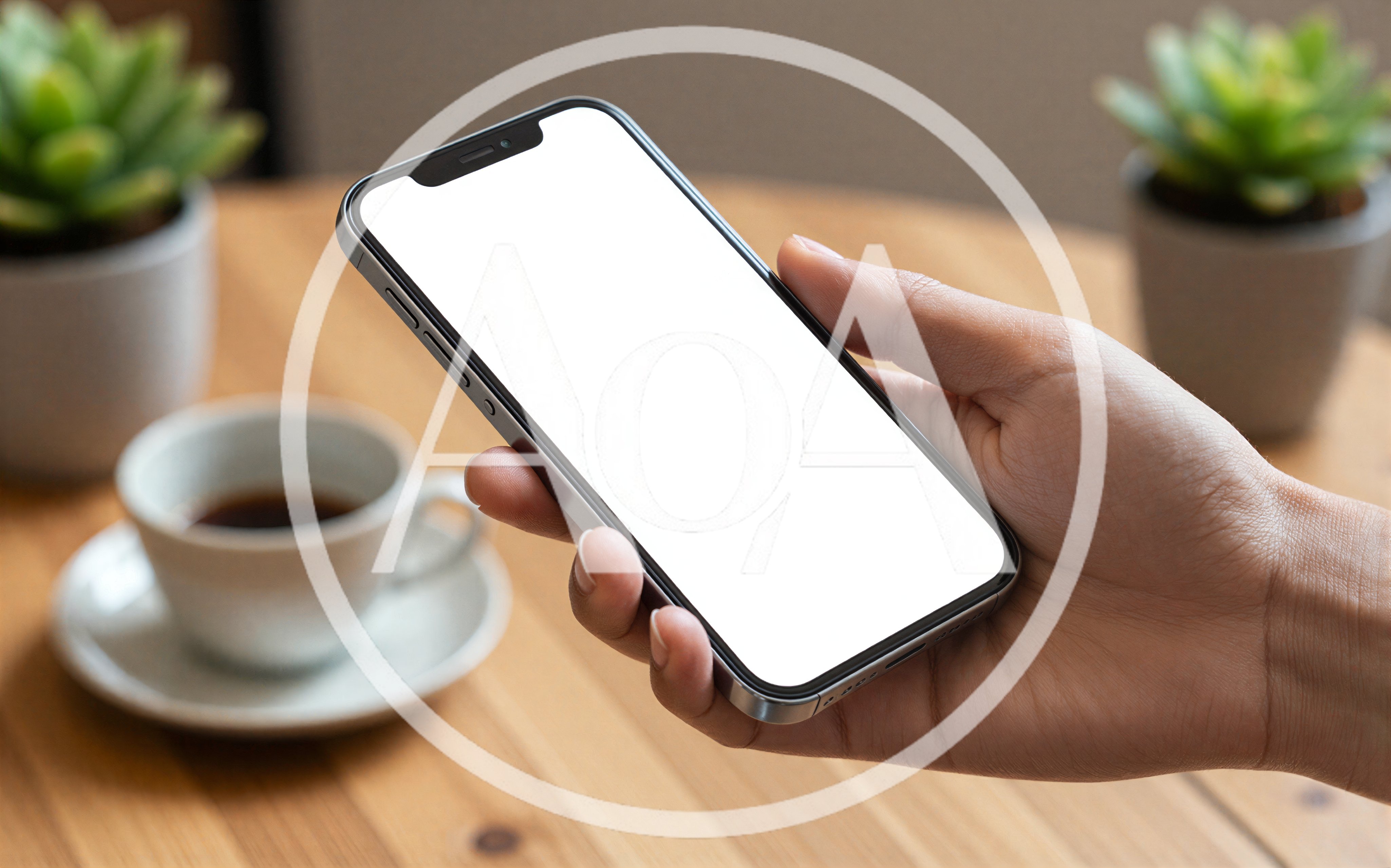 Hand Holding Smartphone With Blank Screen On Table