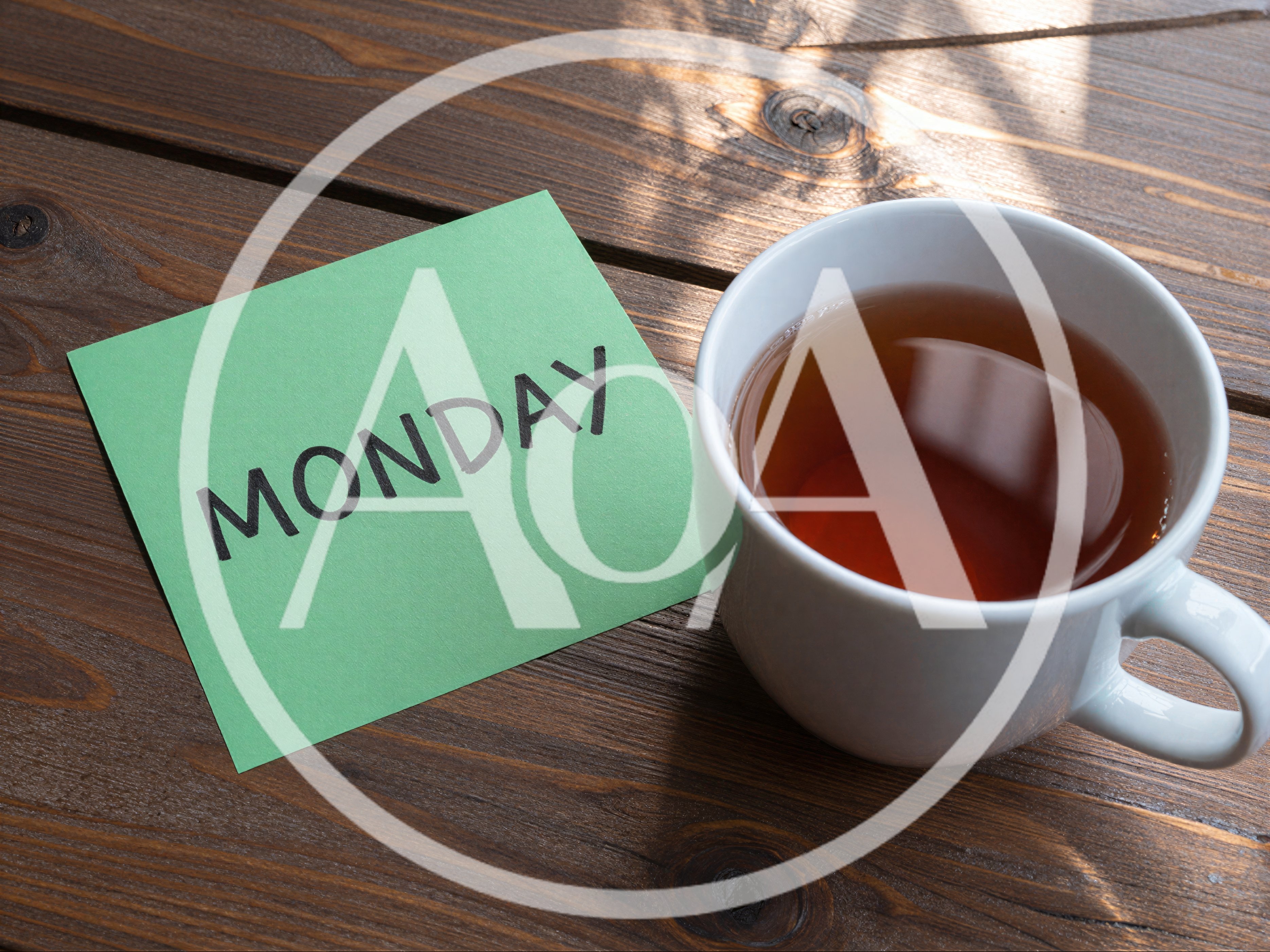 Green Note With Monday Written On Wooden Table