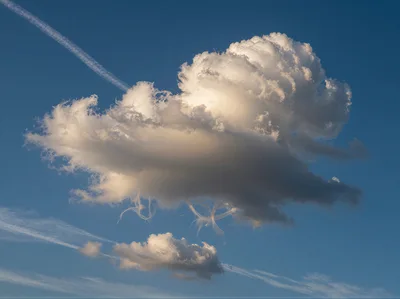 Single Large Cumulus Cloud With Wispy Trails
