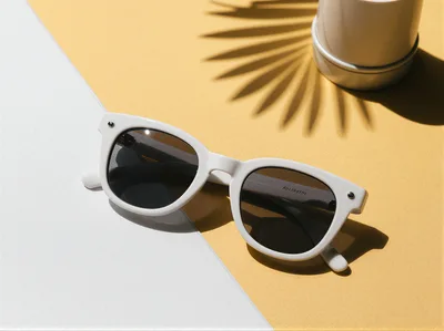 White Sunglasses On A Yellow And Grid Background