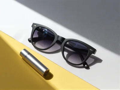Sunglasses And Metal Lipstick Tube On Geometric Background
